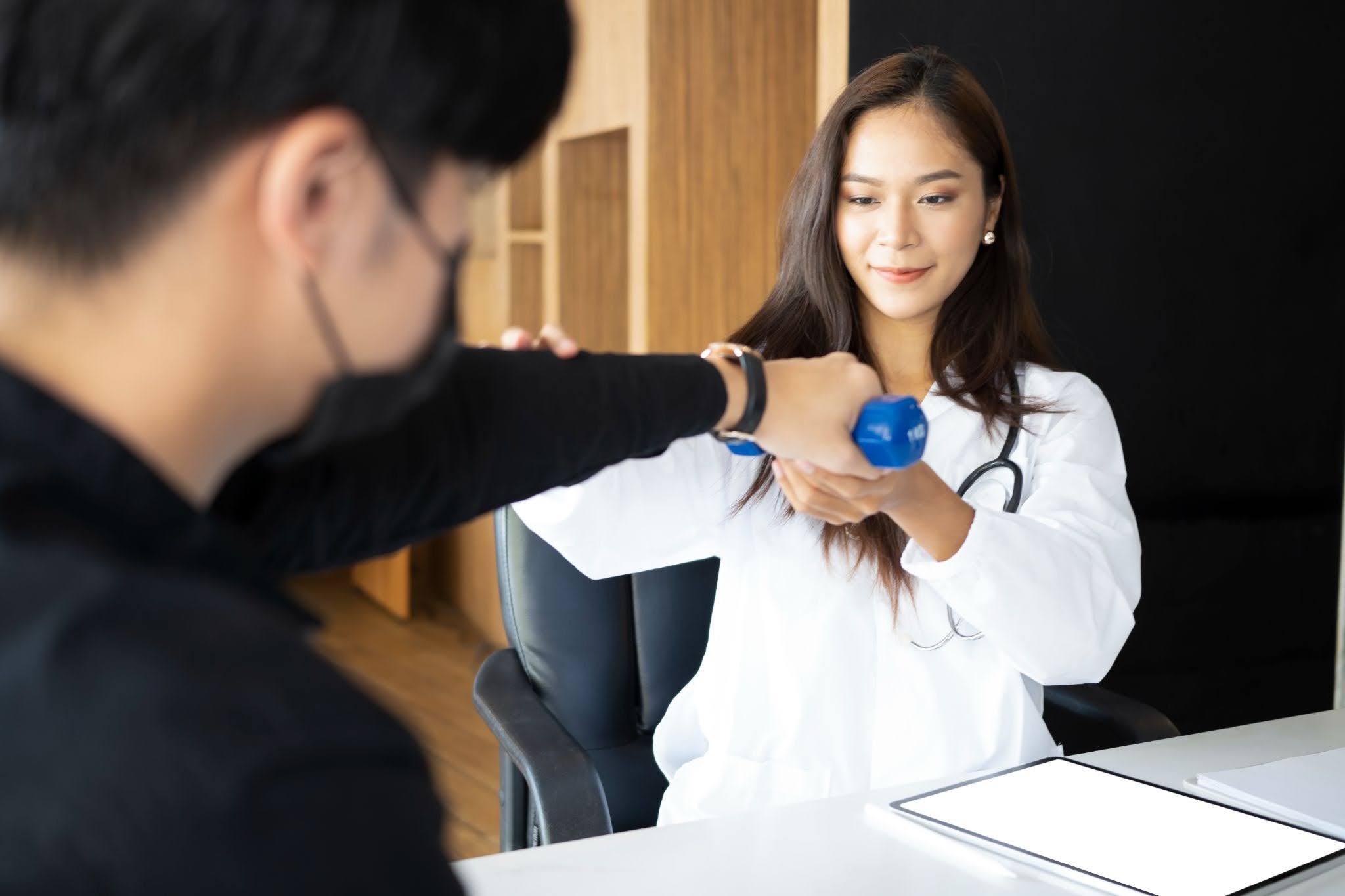 a doctor is checking a patient arm
