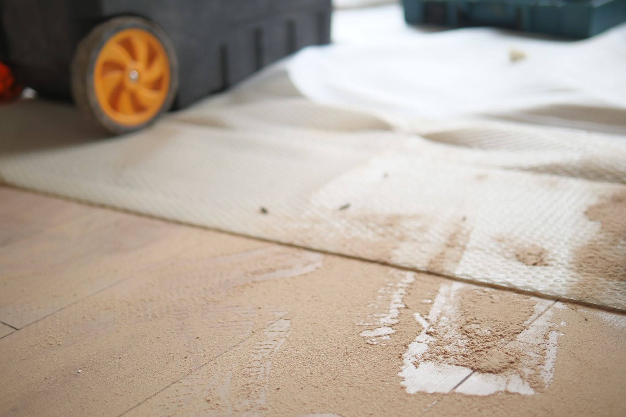 Fine renovation dust settled on floors and surfaces after carpentry and painting works