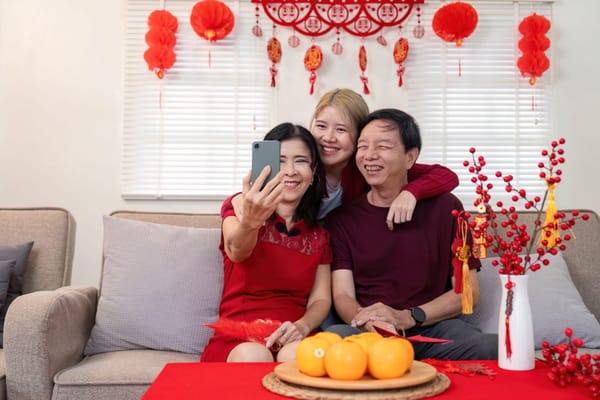 A happy family takes a selfie in a spotless living room decorated for Chinese New Year