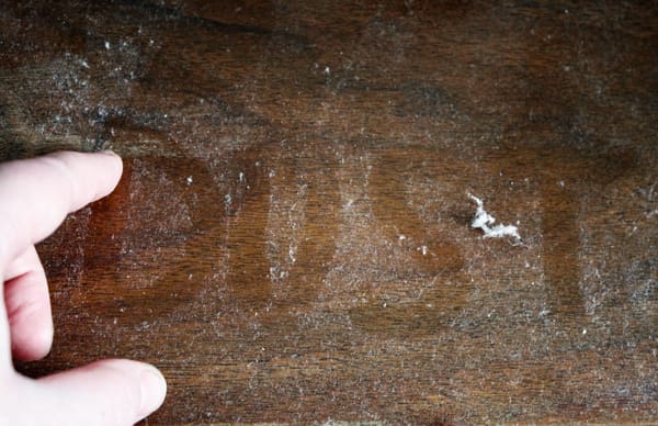 the word dust written on a pile of dust